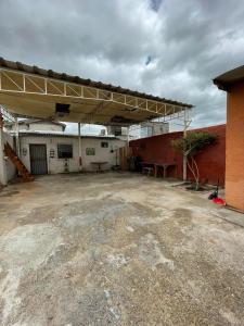 an empty parking lot in a building with a roof at Casa De la Rosa in Piedras Negras