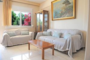 a living room with a couch and a table at Katia's House in Ampavris