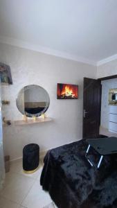 a bedroom with a bed and a mirror on the wall at Appartement meublé en location nuitée in El Jadida +5 photos