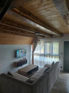 a living room with a couch and a tv at Vikendica Buzadzija M&N 
