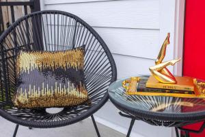 a glass table with a book and a chair with a pillow at Rooftop Deck Hot Tub Fire pit Sleeps 10 in Nashville +40 photos