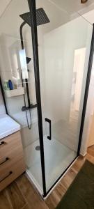 a shower with a glass door in a bathroom at Canet Plage - Maison 3 chambres in Canet-en-Roussillon