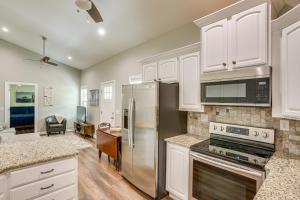 a kitchen with white cabinets and stainless steel appliances at half Mi to Kentucky Downs Franklin Home with Patio! in Franklin
