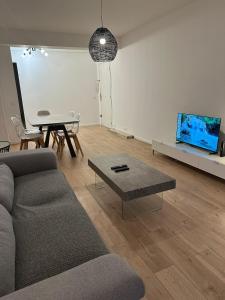 a living room with a couch and a table at 2 Bedroom Ocean view Apartment in Nice