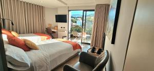 a hotel room with two beds and a balcony at Hotel Living 35 Suites Piso 8 Vip in Medellín
