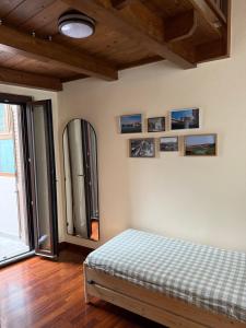 a bedroom with a bed and a mirror on the wall at Casa Teresina in Mercatale