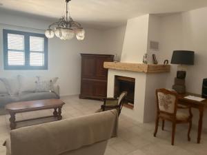 a living room with a couch and a fireplace at Entre mer et maquis- maison avec piscine privée - 8 minutes plage tizzano in Sartène