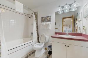 a bathroom with a toilet and a tub and a sink at Sandy Cay 246 in Salvo +18 photos