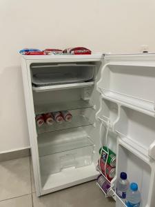an open refrigerator filled with drinks and sodas at Hotel Califórnia Cruz Alta in Cruz Alta