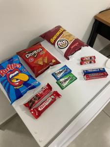 a white table with snacks on top of it at Hotel Califórnia Cruz Alta in Cruz Alta