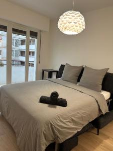 a bedroom with a bed with a stuffed animal on it at 2 Bedroom Ocean view Apartment in Nice