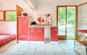a kitchen with a red refrigerator in a room at Cozy Home In Les Eyzies in Les Eyzies-de-Tayac