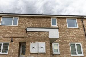 a brick building with numbers on the front of it at Cambridge House near Addenbrookes, parking and WiFi in Shelford