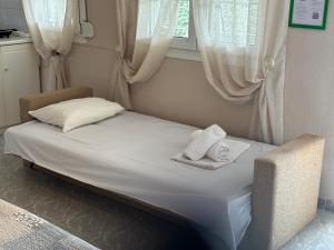 a small bed in a room with towels on it at Sykia Itamos Studio-2 in Sykia Chalkidikis +27 photos