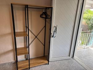 a sliding glass door with a shelf next to a house at Sykia Itamos Studio-2 in Sykia Chalkidikis