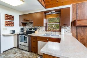 a kitchen with a sink and a stove at Cozy Chalet & Luxe Domes Retreat w Stunning Views in Augusta +36 photos