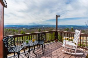 a deck with two chairs and a table and chairs at Cozy Chalet & Luxe Domes Retreat w Stunning Views in Augusta