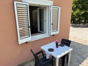 a white table and chairs in front of a window at Casa di Mael in Maratea +13 photos