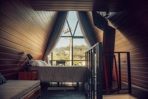 a room with a bed and a large window at Tena Tower House TTH in Tena