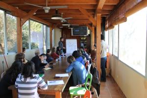 a group of people sitting at tables in a restaurant at Centro de Agroecologia y Medio Ambiente de Murcia in Bullas