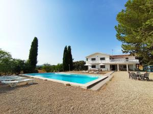 a large swimming pool in front of a house at Casa Rural El Contarín - An Andalusian Escape, Archidona, Malaga in Archidona