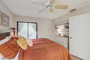 a bedroom with a bed and a ceiling fan at After Dune Delight in New Smyrna Beach +25 photos