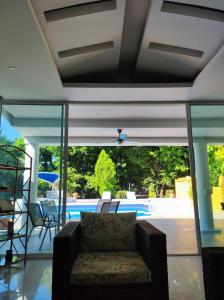 a living room with a couch and a pool at Casa Condominio El Peñón Girardot in Girardot +78 photos