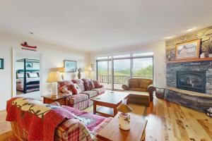 a living room with a couch and a fireplace at Reserve 05-C in Sugar Mountain