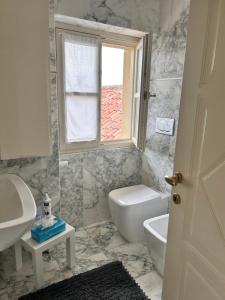 a bathroom with a sink and a toilet and a window at Bon Bon Luxury di piazza San Secondo in Asti +32 photos