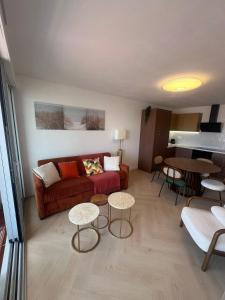 a living room with a couch and a table at Beautiful apartment with sea view in Le Grau-du-Roi