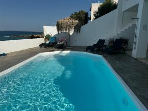 The swimming pool at or close to NV seafront Villa Aegina