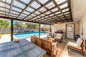 a living room with a table and a pool at 721 Java Rd in Cocoa Beach