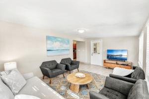 a living room with a couch and chairs and a table at 721 Java Rd in Cocoa Beach