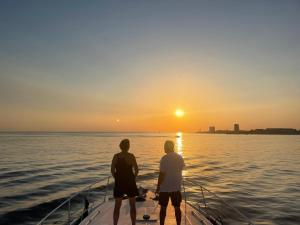 a man and woman standing on a boat looking at the sunset at yacht Twenty Seven in Les Sables-d'Olonne +17 photos