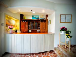 a kitchen with a counter with flowers on it at Hotel Argibay in O Grove