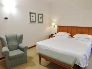 Postel nebo postele na pokoji v ubytování Hotel Excelsior Magenta