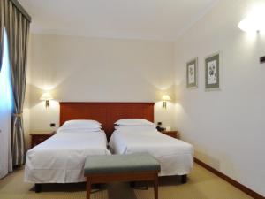 Postel nebo postele na pokoji v ubytování Hotel Excelsior Magenta