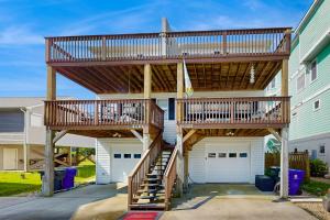 a wooden deck on the side of a house at Shell of the Ball - B in Carolina Beach