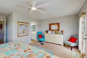 a bedroom with a bed and a chair and a dresser at Shell of the Ball - B in Carolina Beach
