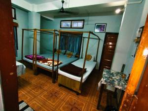 a bedroom with two bunk beds in a room at Namaskar Lodge and Homestay in Guwahati +37 photos