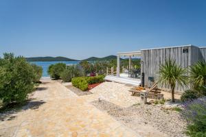 a house on the shore of a lake at Villa Nautilus Buqez Resort in Drage