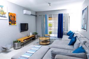 a living room with a couch and a tv at Mills Pad with 2-bedroom in Nelspruit