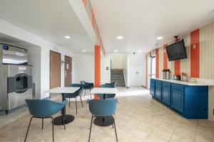 a room with tables and chairs and a tv at Studio 6 Limon, CO I 70 in Limon