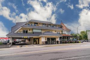 a building on the corner of a street at Prestige Beach House, WorldHotels Crafted in Kelowna