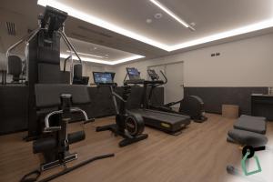 a gym with several exercise equipment in a room at HOTIDAY Room Collection - Milano Cinque Giornate in Milan