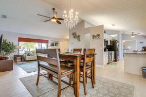 a dining room and living room with a table and chairs at Private Pool and Yard Family Home in Port St Lucie in Walton