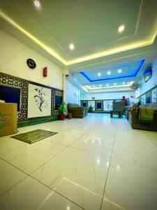 a large room with a lobby with couches at AL AQSA SUiTES Guest House Islamabad in Islamabad