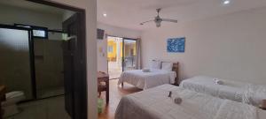 a bedroom with two beds and a room with a window at Hotel Iker in Tulum +157 photos