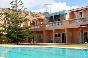 a villa with a swimming pool in a resort at L'oasis d'Agadir - Agadir's hidden Oasis in Agadir +25 photos