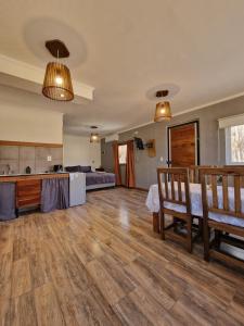 a large living room with wooden floors and two lights at Cabaña Lumen in Uspallata +14 photos